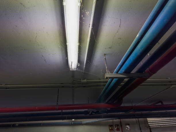 istock Industrial Aesthetics: Overhead Pipes and Fluorescent Light 1907597320