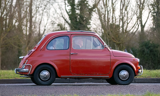 Stony Stratford,UK Jan 1st 2024. 1972 red Fiat 500 classic car arriving at Stony Stratford for the annual New Years Day vintage and classic vehicle festival.