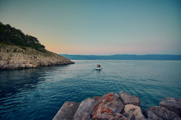 adriatic beach with blue sea at sunset