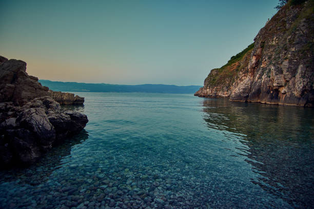 adriatic beach with blue sea at sunset