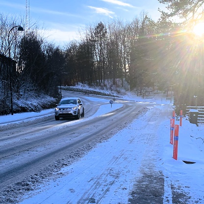 On a winter morning in Holte, a suburban area of Copenhagen, traffic navigates the icy roads. The photograph captures the scene on January 3, 2024 in Denmark.