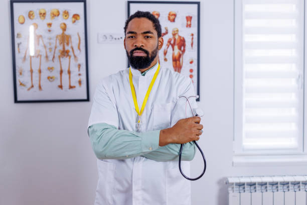 Expert technician in healthcare setting A professional portrait of an African-American technician in a healthcare setting, his expertise crucial in the smooth operation of medical services male nurse male healthcare and medicine technician stock pictures, royalty-free photos & images
