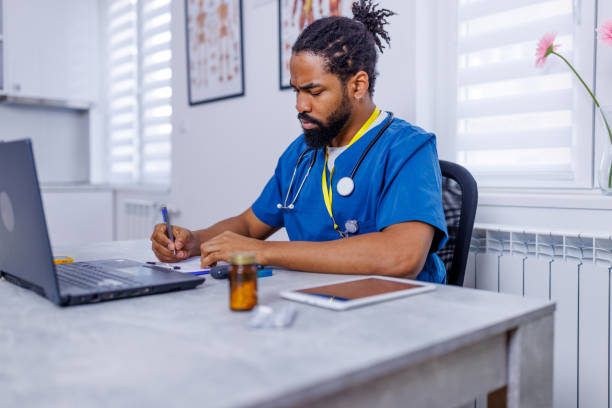 istock Male nurse's adept use of technology in care 1907657504