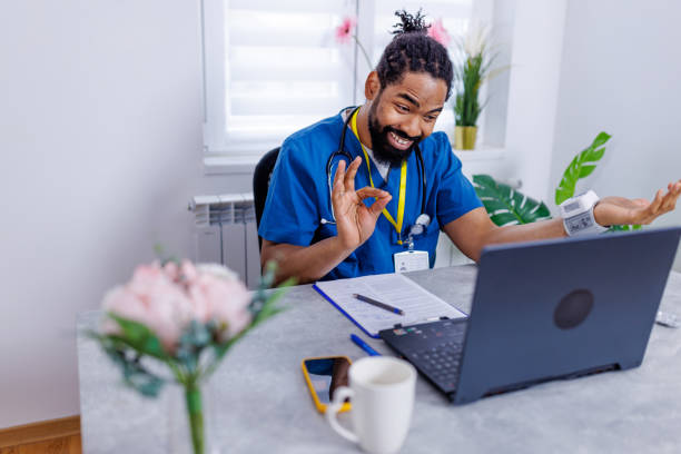 Healthcare worker's virtual patient consultation An engaging scene of a healthcare worker using a laptop for a video call, showcasing how modern technology bridges the gap between medical professionals and patients male nurse male healthcare and medicine technician stock pictures, royalty-free photos & images