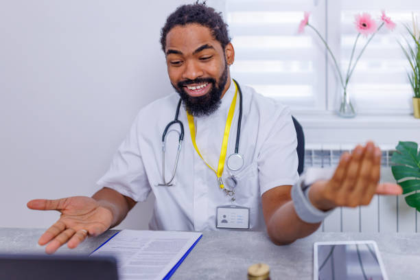 Healthcare professional engaging in virtual healthcare A scene depicting a healthcare professional, deeply engrossed in a video call with a patient, demonstrating the effective use of technology in modern medical practices male nurse male healthcare and medicine technician stock pictures, royalty-free photos & images