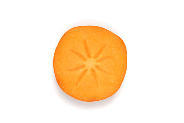 Two ripe orange persimmon, one sliced isolated on a white background. Studio shot.