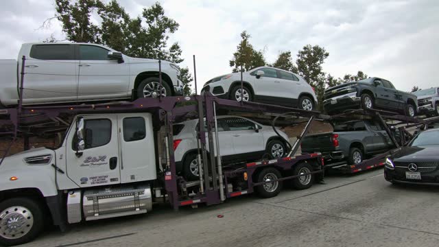 Car transporter carries new cars, vehicles along the I-10 highway from Los Angeles to Las Vegas