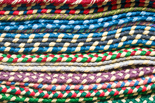 Background of a stack of hand braided rugs found in a Lancaster County, Pennsylvania shop.