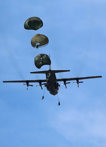 Palangka Raya City, Central Kalimantan Province, Indonesia - July 2, 2016 - Republic of Indonesia military personnel carry out parachuting training from a transport aircraft.