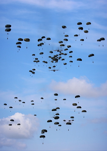 Palangka Raya City, Central Kalimantan Province, Indonesia - July 2, 2016 - Republic of Indonesia military personnel carry out parachuting training from a transport aircraft.