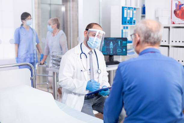 istock Doctor wearing visor 1907713180
