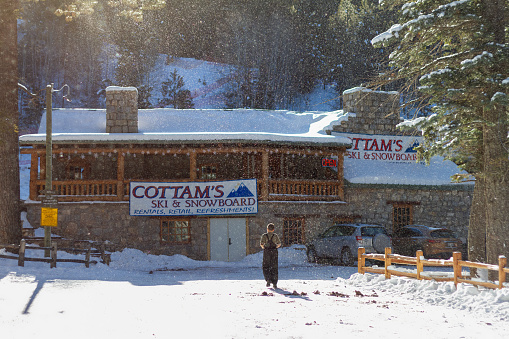 Santa Fe, New Mexico, United States - 27 Dec 2009:  A person walks towards Cottam's Ski and Snowboard rentals in Santa Fe, New Mexico, on a snow day.