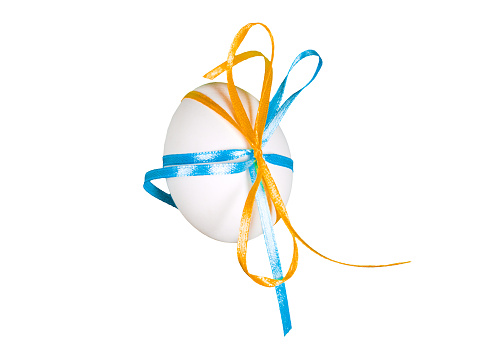 Easter egg with blue and yellow ribbons isolated background. Minimal easter style design concept Happy Easter. Spring holiday