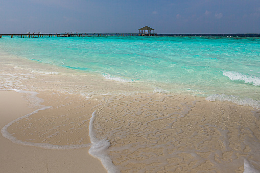 A photo of a stunning view of a beach in the Maldives. Paradise island