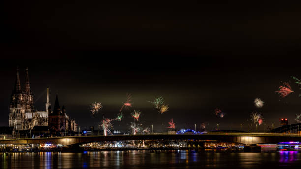 Cologne, Germany - Dec 31st 2023: Riverbanks of Rhine river are a famous place for fireworks in Cologne, Germany.