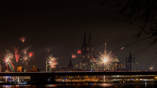 Cologne, Germany - Dec 31st 2023: Riverbanks of Rhine river are a famous place for fireworks in Cologne, Germany.