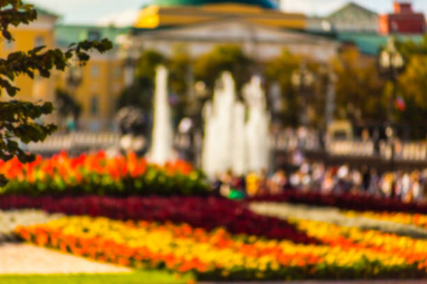 extured Background Photography. People walking in the park. Blurred photo.