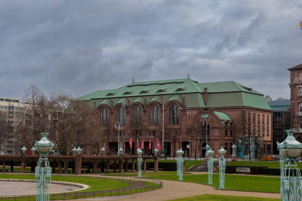 Mannheim, Germany - Dec 29th 2023: Rosengarten formal garden in Mannheim is surrounded by historical buildings.
