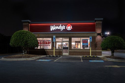 Fort Mill, South Carolina, United States - 24 Dec 2023:  Wendy's Restaurant in Fort Mill, South Carolina, closed and lit with the stars above.
