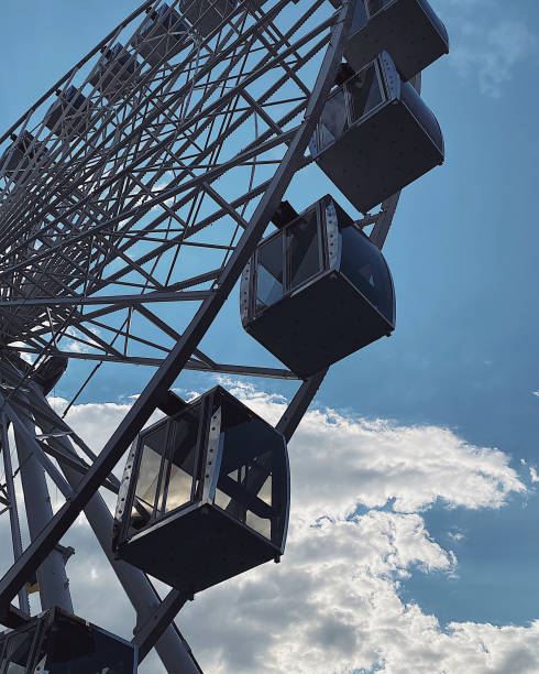 istock ferris wheel on the background of a blue sky with white clouds 1907781399