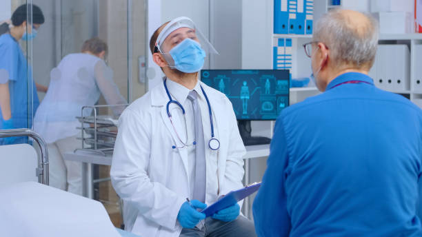 istock Doctor consulting patient during COVID 19 1907806820