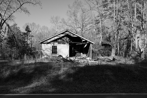 Old and burned out house in the woods.