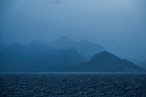 Cloudy weather. View of the sea and mountain ranges.