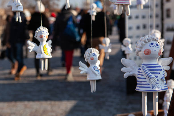 Souvenirs angels, Prague, Czech Republic Figures of angels and dolls sold on the Charles Bridge in Prague. Selective focus. prague art stock pictures, royalty-free photos & images