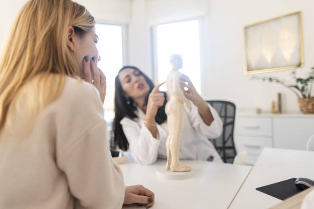 istock Doctor showing anatomical model to patient 1907846407