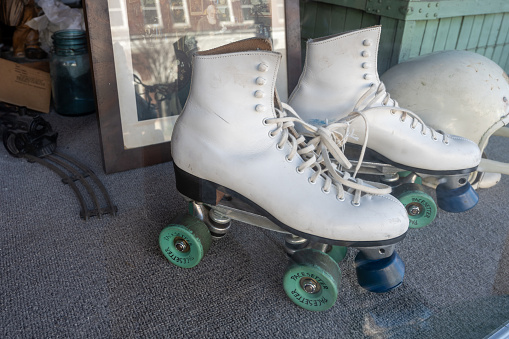 Lancaster, South Carolina, United States, 31 Dec 2023:  Window of an antique store featuring old roller skates.