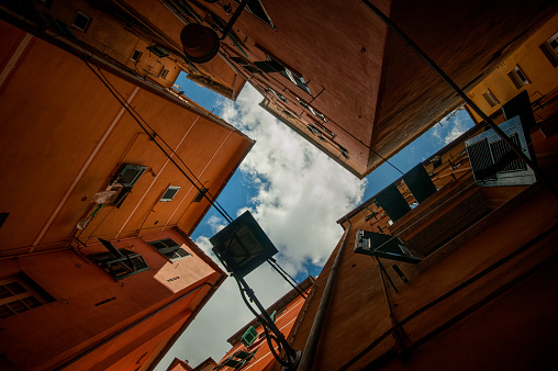 narrow, colorful streets, lanterns and courtyards, bottom view, geometry of facades, Liguria, Genoa, Italy
