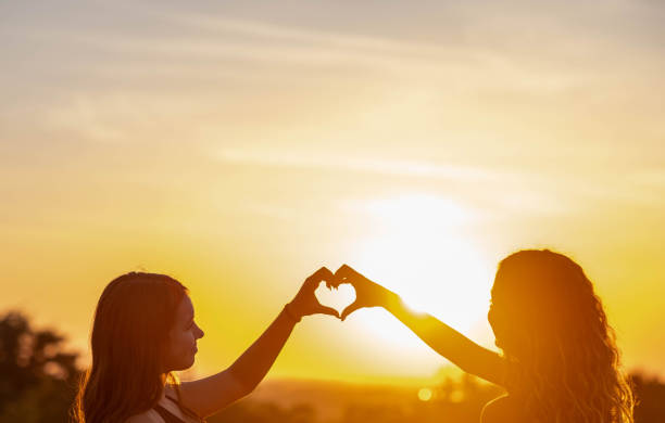 girls making a heart shape