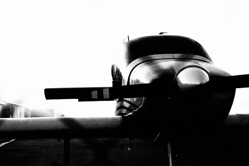 An airplane on the ground, in black and white