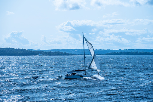 Moss, Norway - August 27 2023: Sailboat crossing a fjord in strong wind.