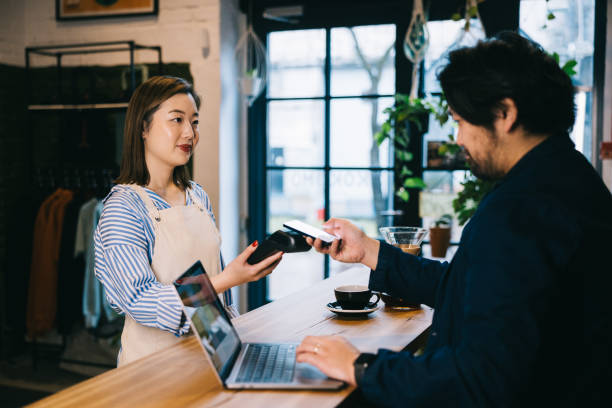istock Japanese man paying with smartphone at a local cafe 1907877400