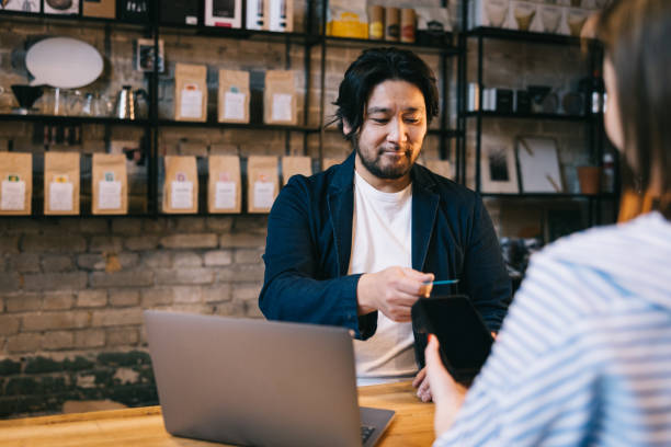 istock Positive businessman making a contactless payment 1907877403