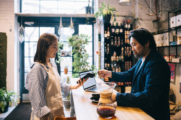 istock Positive businessman making a contactless payment 1907877409