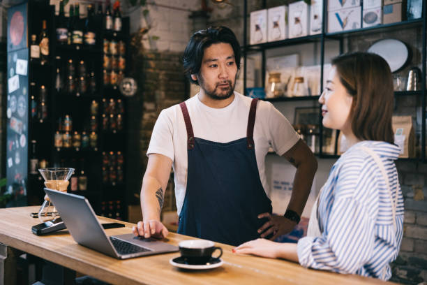 istock Small business coffee roastery owners working behind cafe counter 1907880006