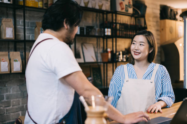 istock Small business coffee roastery owners working behind cafe counter 1907880008
