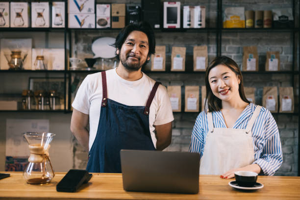 istock Confident Japanese owners standing at their coffee shop 1907880009