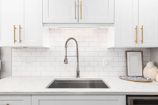 istock A white kitchen faucet detail with a subway tile backsplash. 1907898050