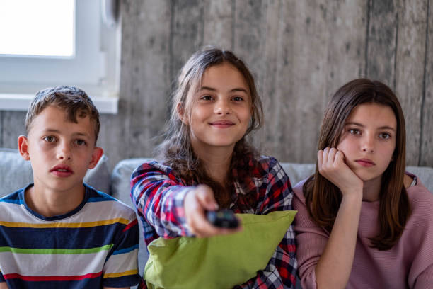 istock three teenagers are watching tv 1907925250