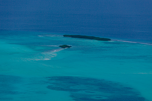 Lakshadweep Union Territory, India: Cherbaniani Reef, aka Beleapani Reef (Malayalam: Valiyapanniyam), coral atoll in the Amindivi islands group - coral reef that encloses the lagoon with three small islands, there is a mosque in the north island - aerial view - Laccadive Sea.