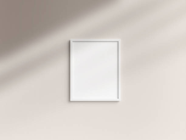 istock Empty 8x10 white photo frame template hanging on the wall 1907969843