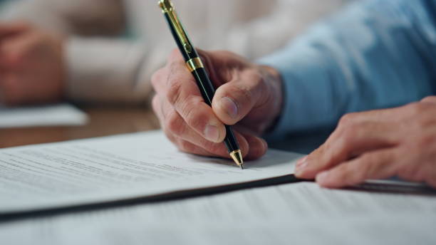 istock Closeup ceo hands signing contract office. Unknown man writing pen signature 1907972917