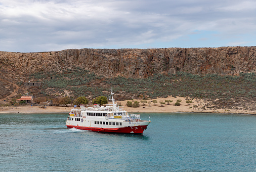 Gramvousa Peninsula, Crete, Greece - September 28, 2023: A picture of a ferry next to the Gramvousa Island.