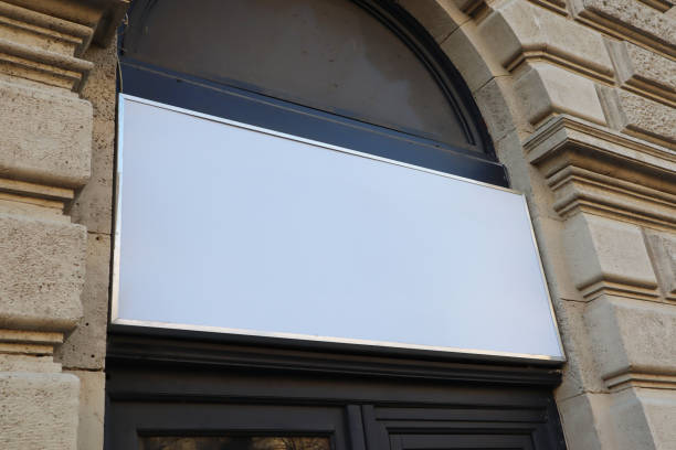 istock Blank billboard sign white mockup in the urban environment on the facade, empty space to display your advertising or branding campaign. 1907984365