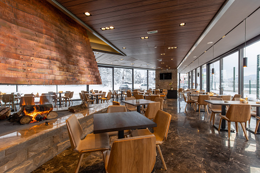 Interior of an empty modern mountain restaurant with marble floor