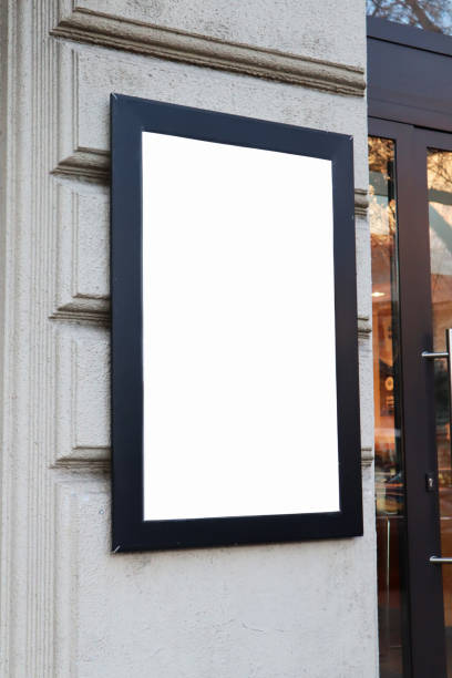 istock Blank billboard sign white mockup in the urban environment on shop window, facade, empty space to display your advertising or branding campaign. 1907985397