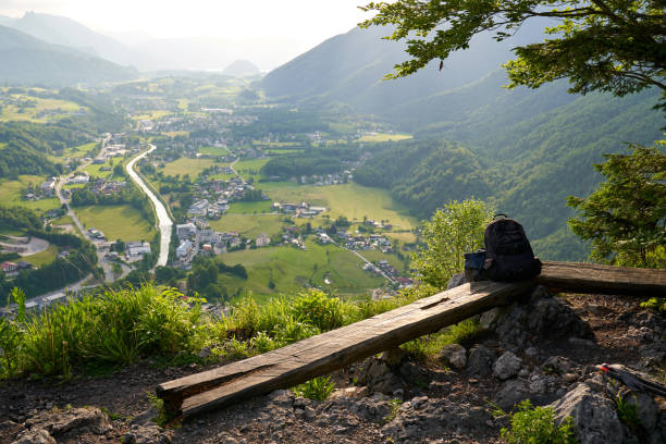 The backpack is lying on a bench in the Alpine mountains.